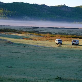 Picture of two UAZ buses in a field.